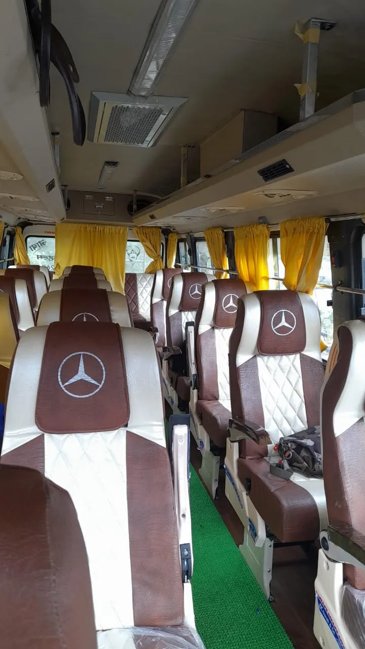 Tempo traveller interior with pushback seats and AC in Pune