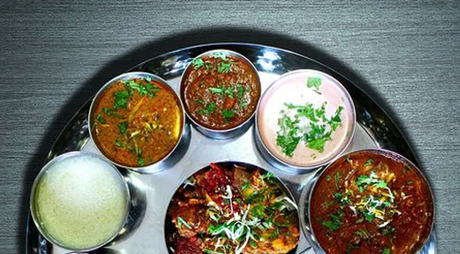 A Kolhapuri mutton thali with tambda and pandhra rassa